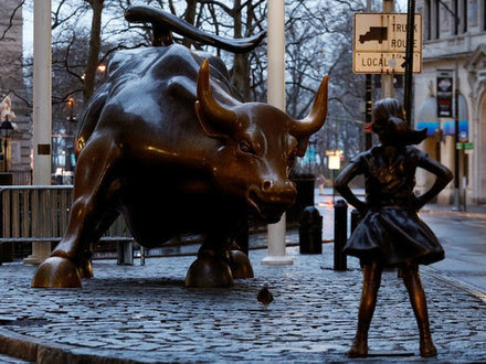 A statue of a girl facing the Wall St. Bull is seen, as part of a campaign by U.S. fund manager State Street to push companies to put women on their boards, in the financial district in New York, U.S., March 7, 2017. REUTERS/Brendan McDermid